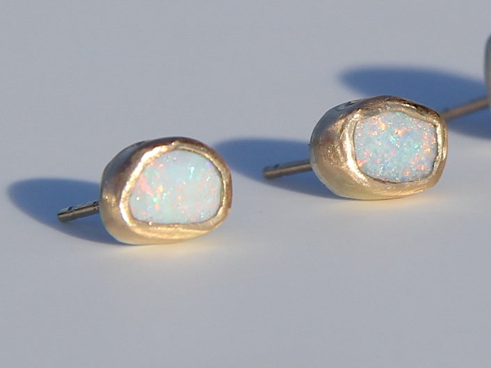 Asymmetrical oval opal studs in gold