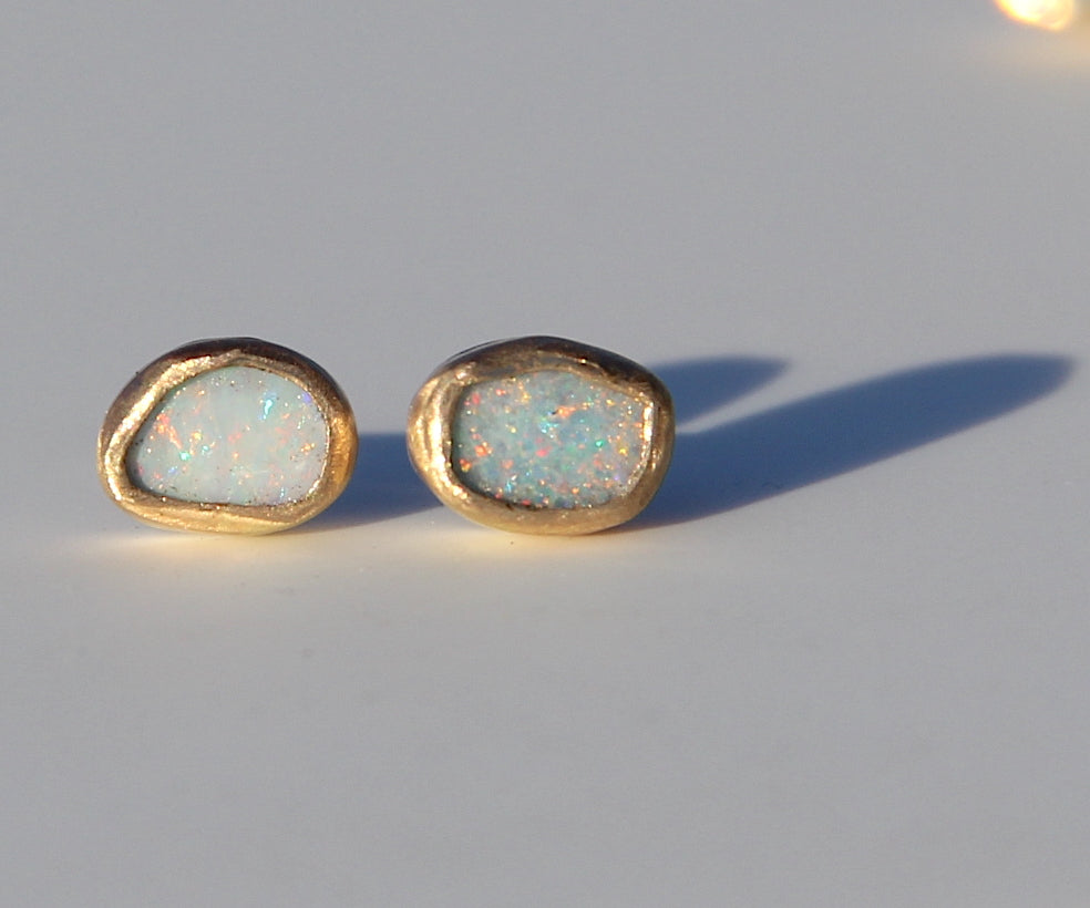 Asymmetrical oval opal studs in gold