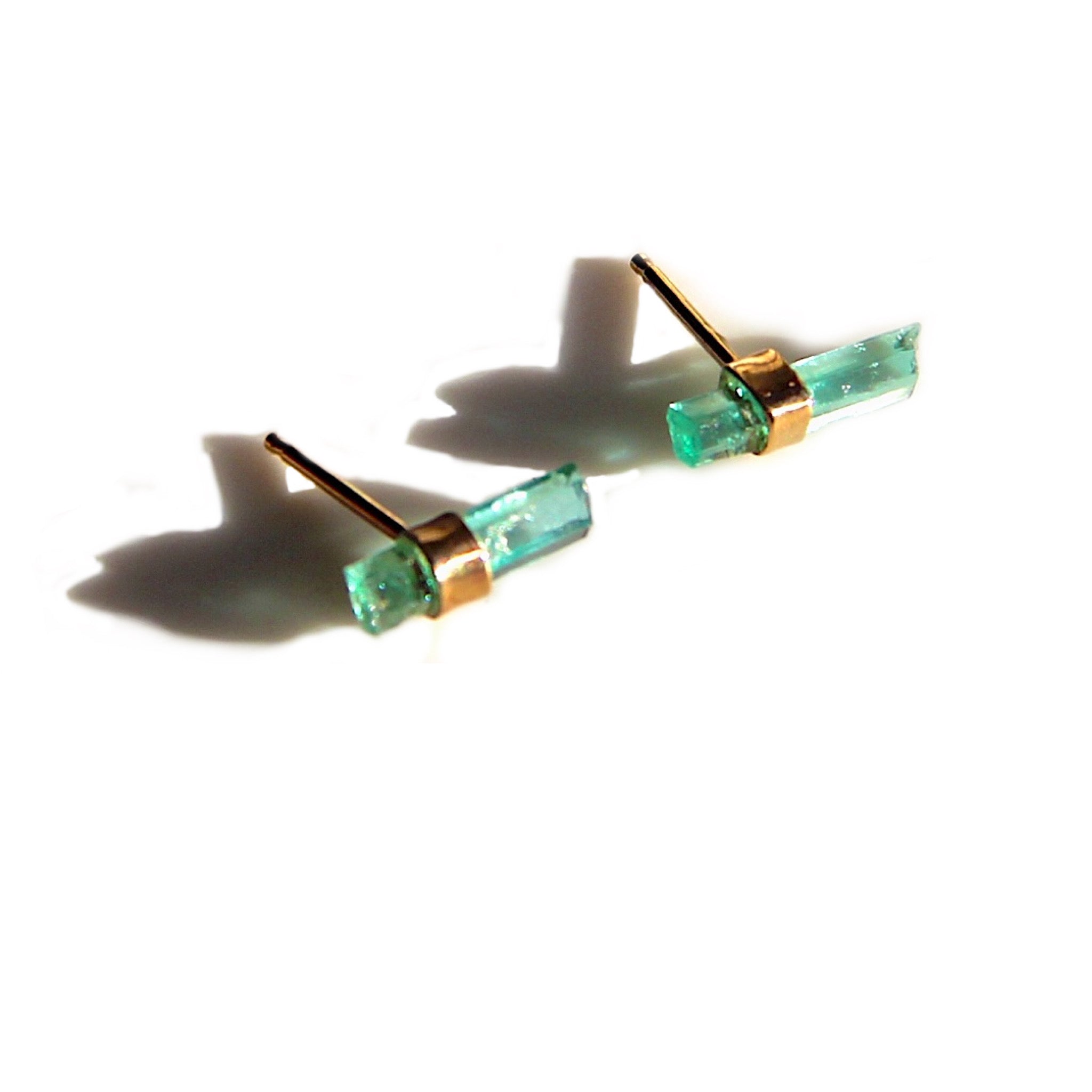 Raw emerald stud earrings in gold